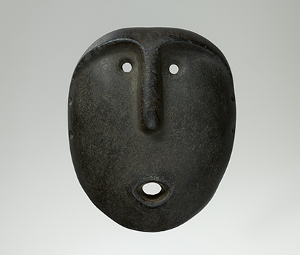 A black mask with small holes for eyes and mouth