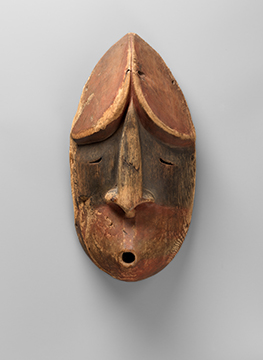 A mask of a face made of wood and pigment